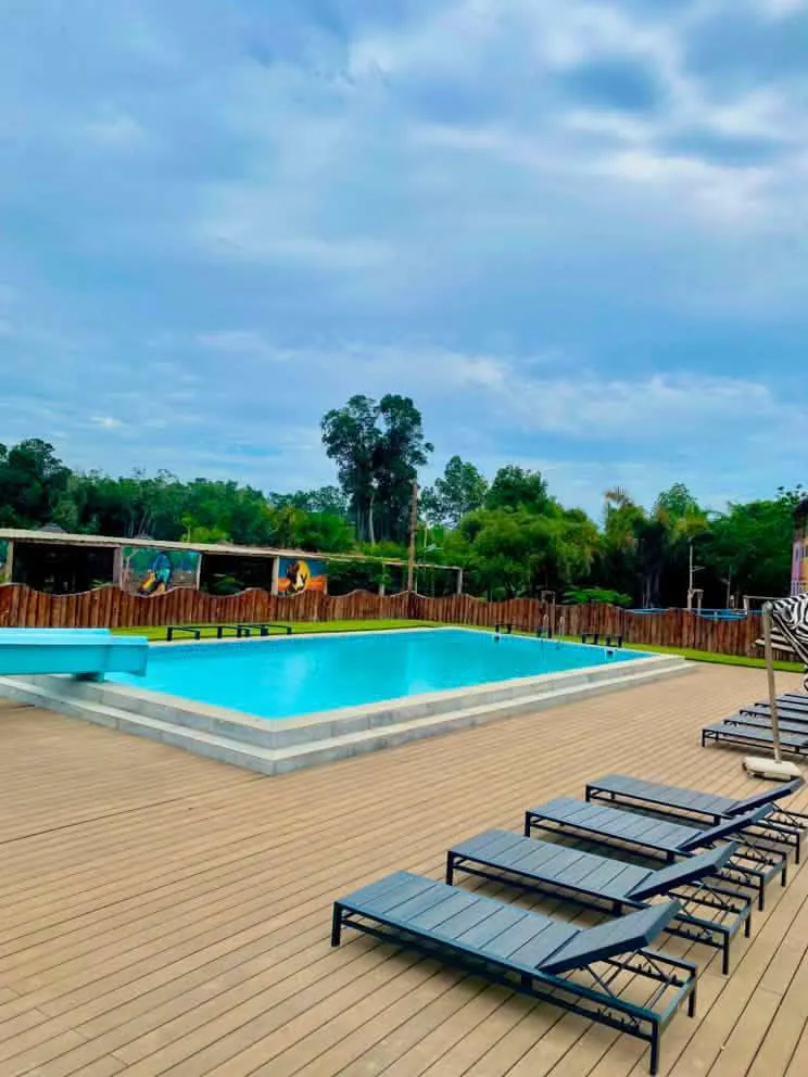 Swimming pool with wooden sun lounger deck